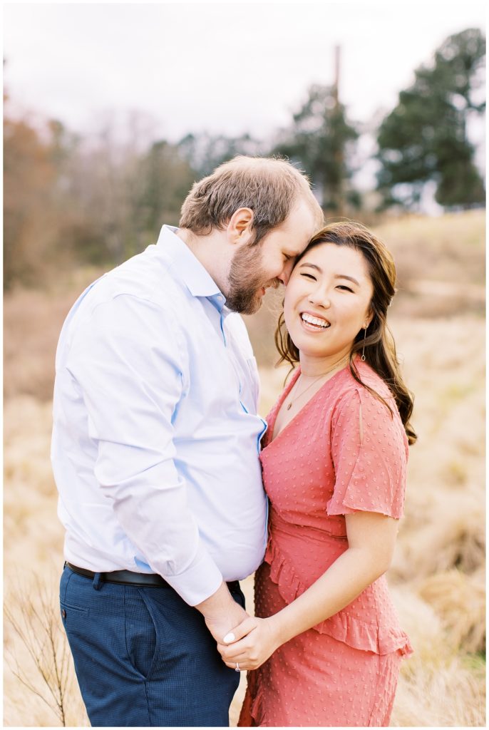 Raleigh engagement session in a field with tall grass at the Raleigh NCMA