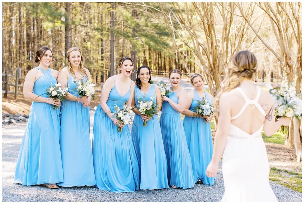 The bridesmaids reaction to seeing the bride for the first time during their first look.