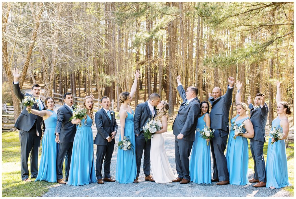 The wedding party wore grey suits and steel blue bridesmaids dresses with blue and white floral bouquets.
