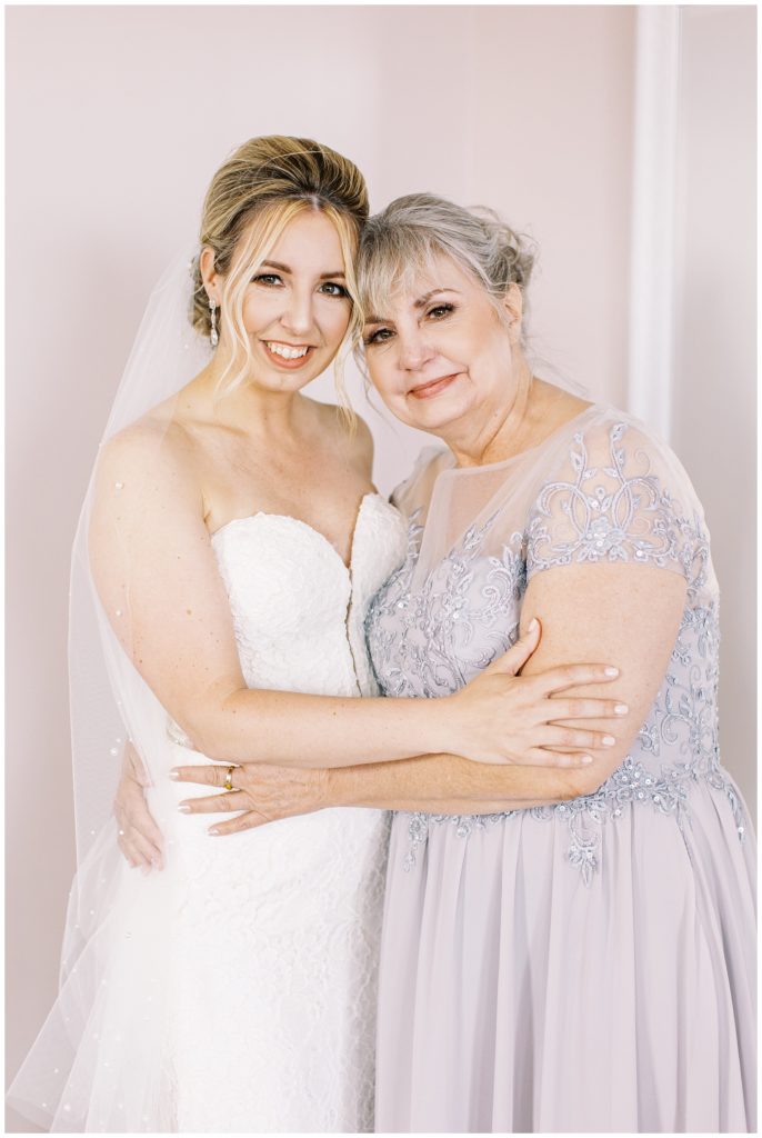 The bride shares a hug with her mom before gifting her an emotional and thoughtful set of gifts on her wedding day.