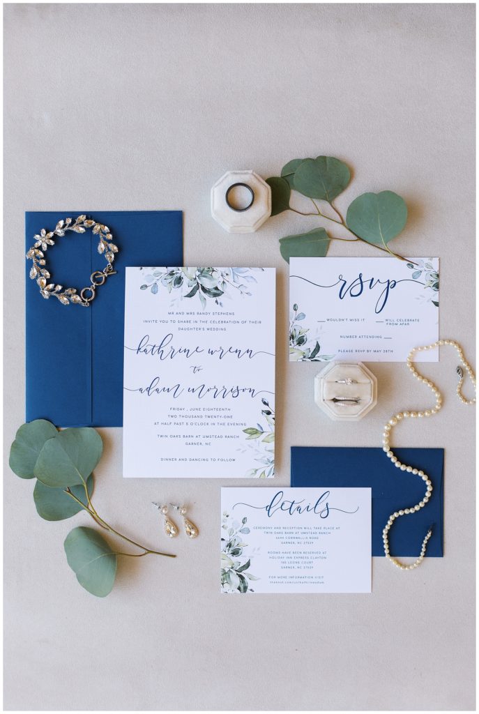 Invitation suite with the bride's jewelry and eucalyptus. 