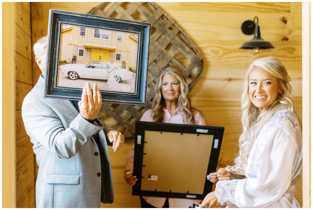 The bride gifts her parents framed bridal portraits that make them cry.