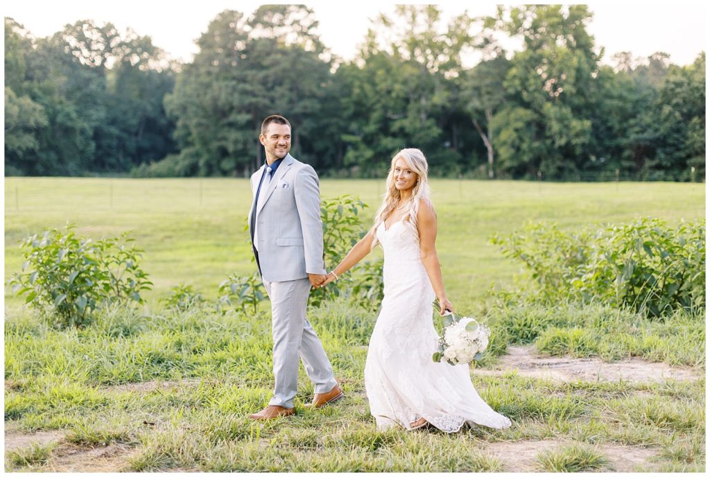Sunset bride and groom portraits on a farm with open fields at Twin Oaks Barn.