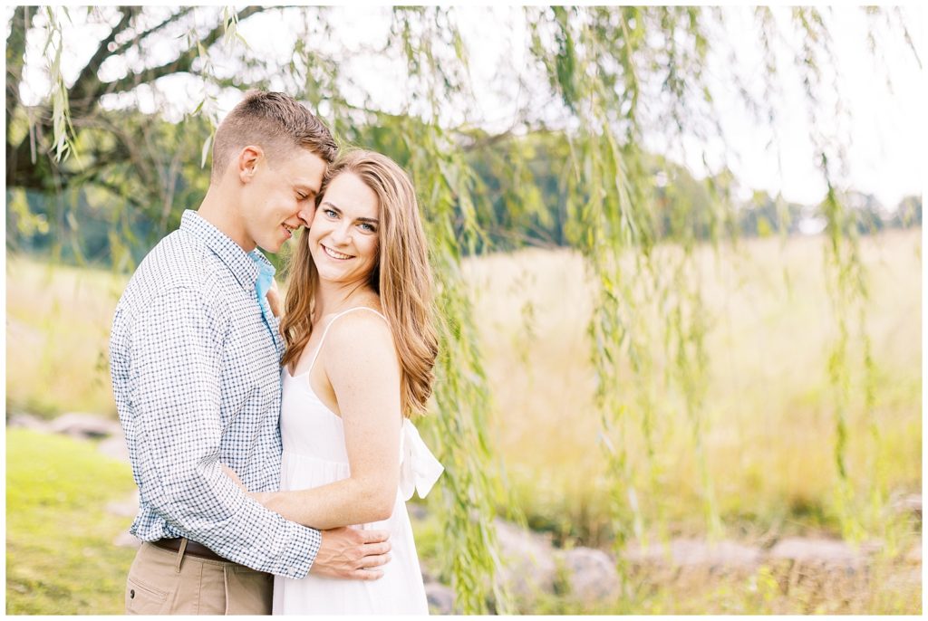 Blue and white engagement photo inspiration in a field.