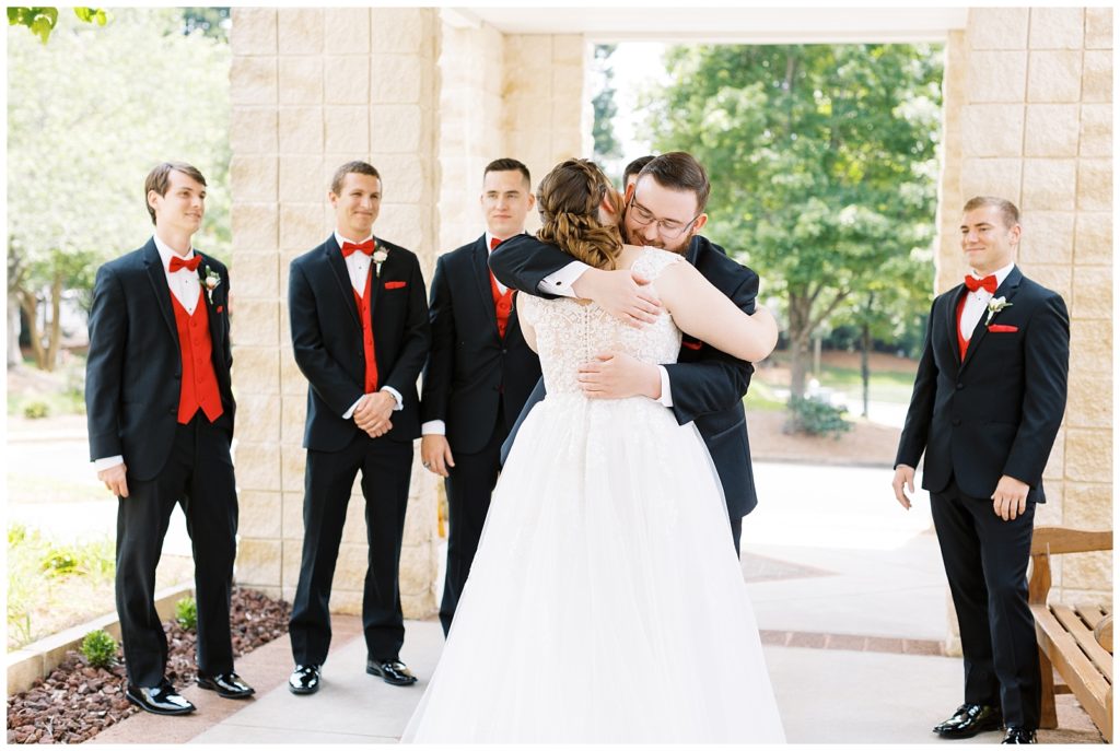 The bride hugs her brother, Peyton, after seeing each other for the first time on the wedding day.