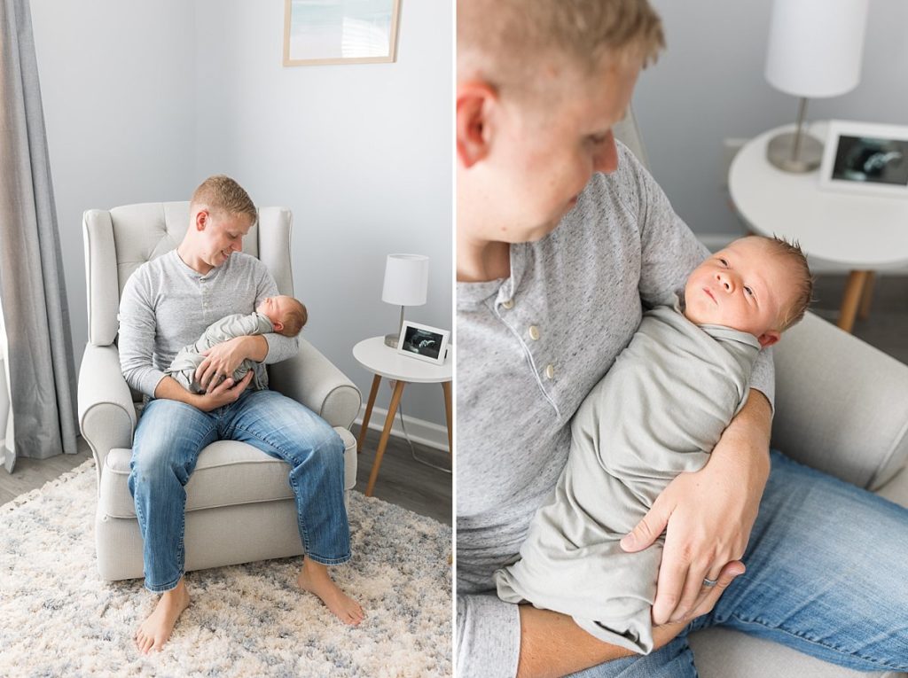 Dad sits in a chair holding his first child
