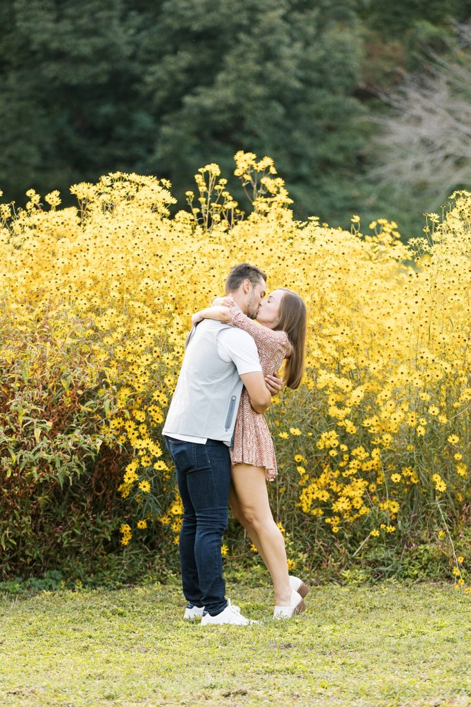 Surprise proposal at Dix Park in Raleigh, NC in a field of yellow flowers.