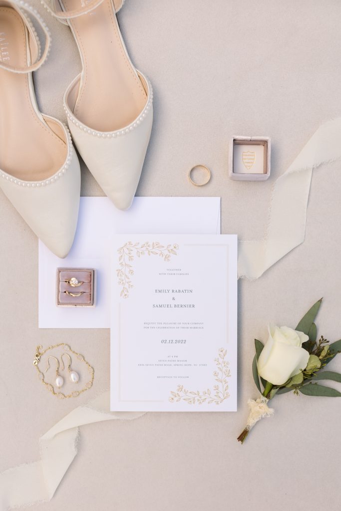 Bridal details of an invitation suite and jewelry at Seven Paths Manor