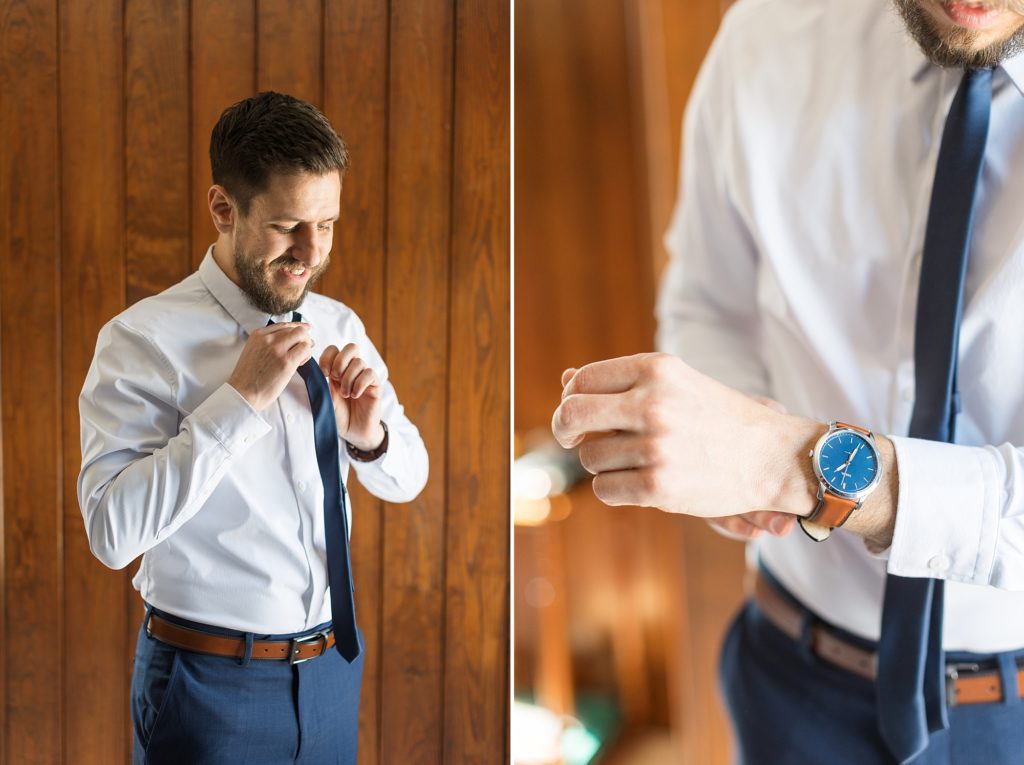The groom ties his tie and puts on a watch on his wedding day | Raleigh Wedding Photographer