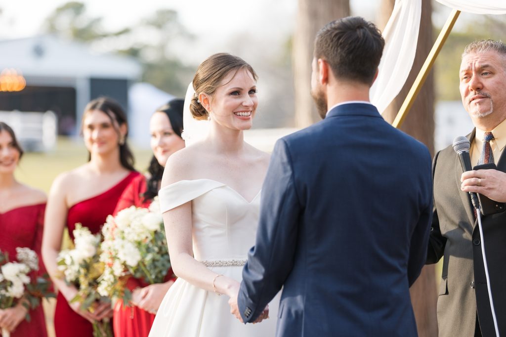 The bride smiles at her groom as they read their vows | Raleigh Wedding Photographer