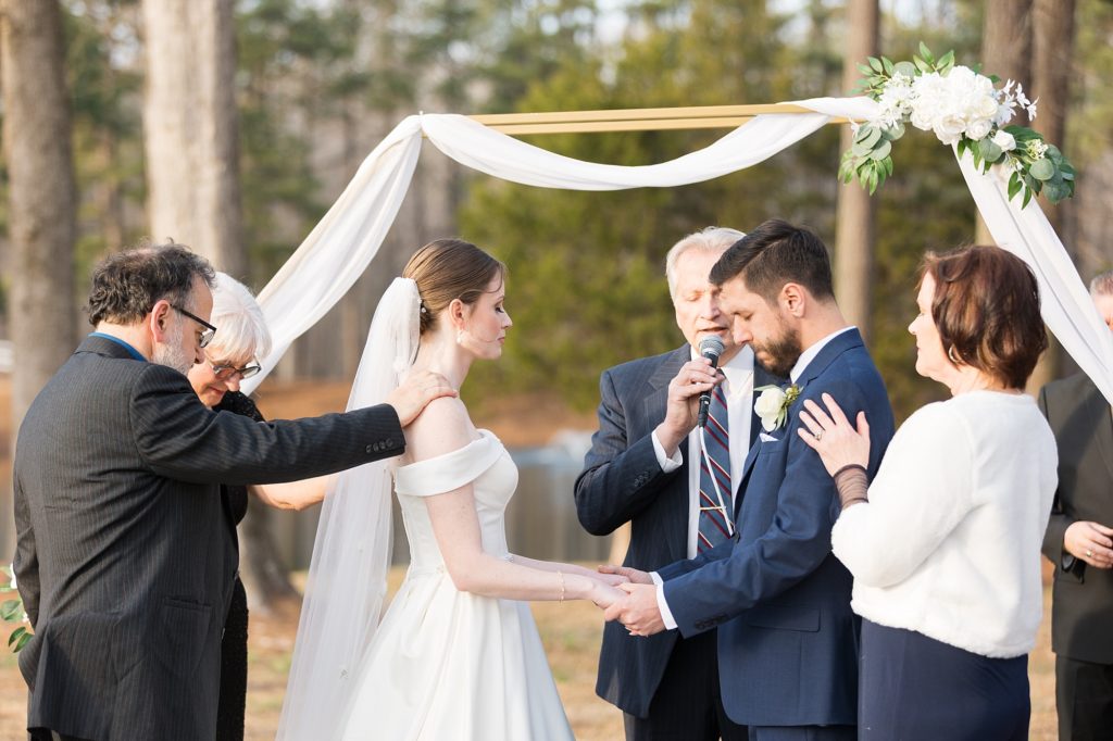 The couples parents came up and prayed over them during the ceremony | Raleigh Wedding Photographer