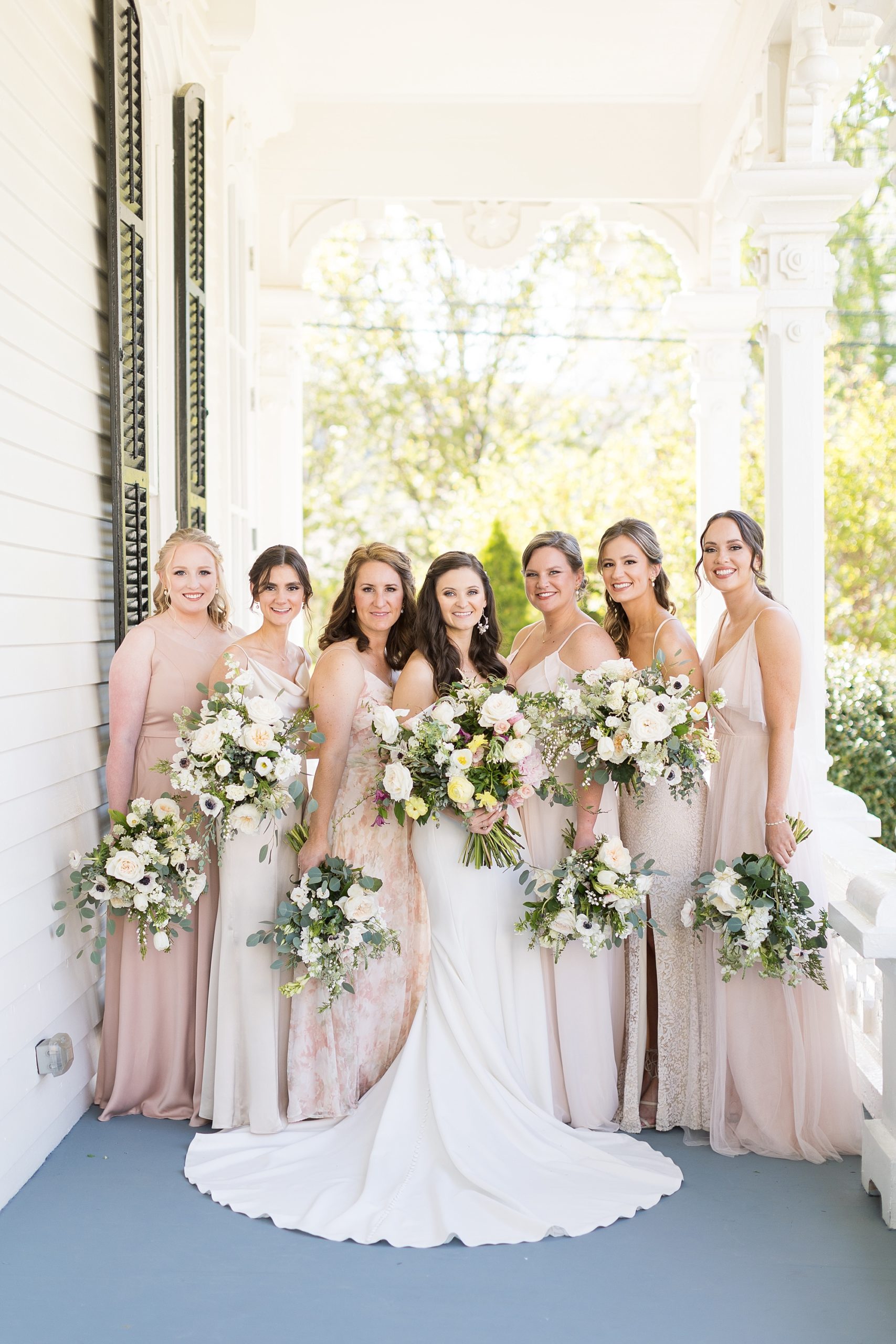 Blush bridesmaids dresses in a variety of colors with white and pink spring florals  | Merrimon Wynne Wedding | Sarah Hinckley Photography | Raleigh NC Wedding Photographer