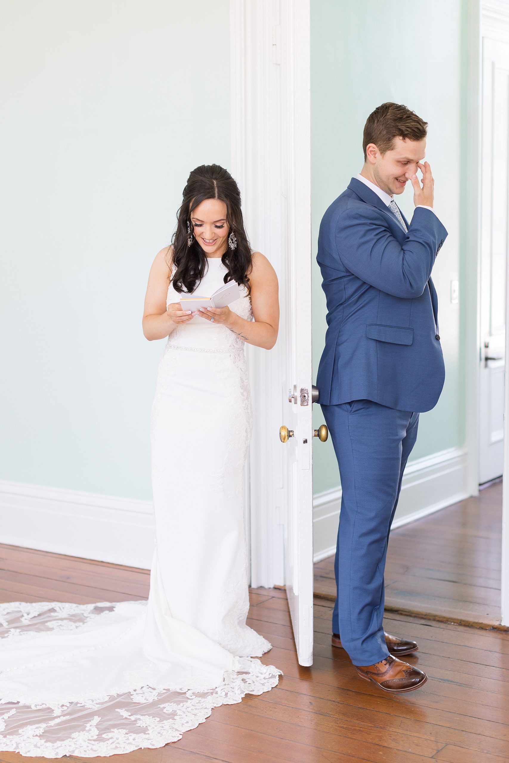 Bride and groom reading notes to each other behind door | Raleigh NC Wedding Photographer