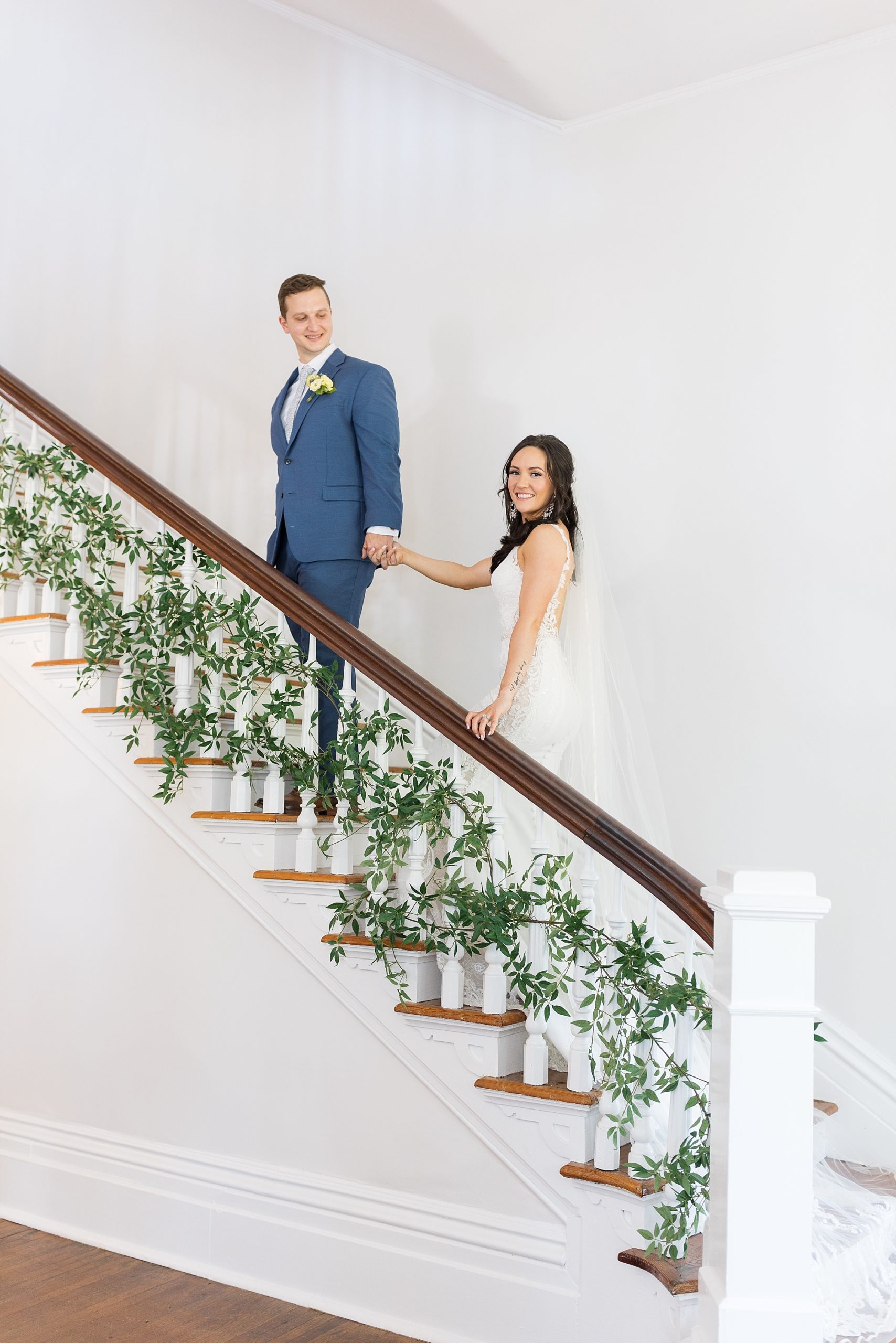 bride and groom walking up staircase | Raleigh NC Wedding Photographer