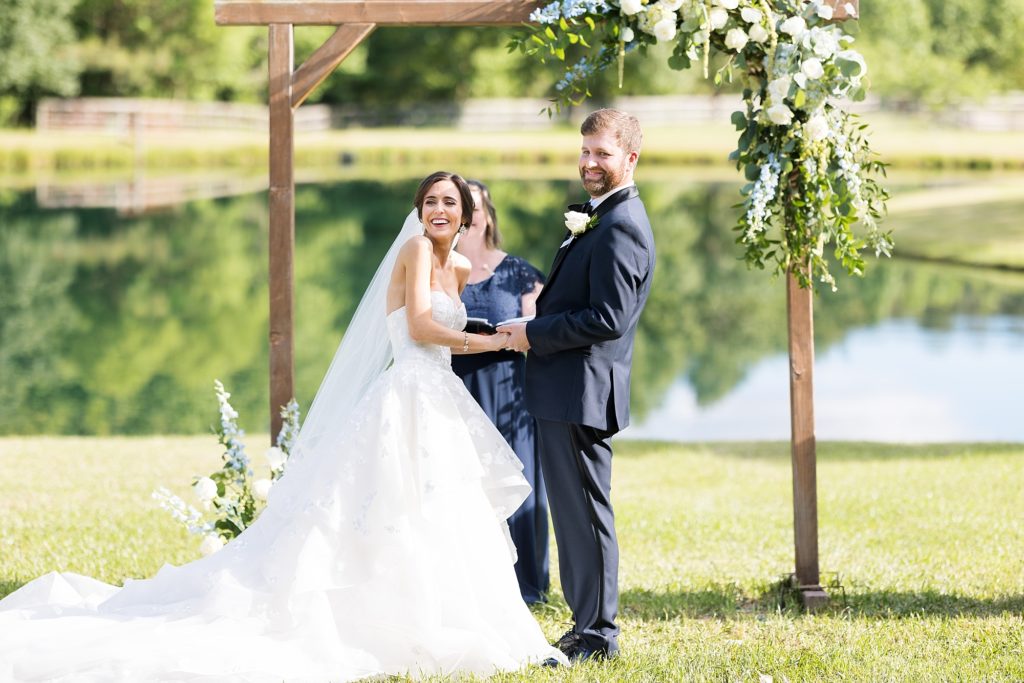 bride and groom smiling at their guests  | Raleigh NC Wedding photographer