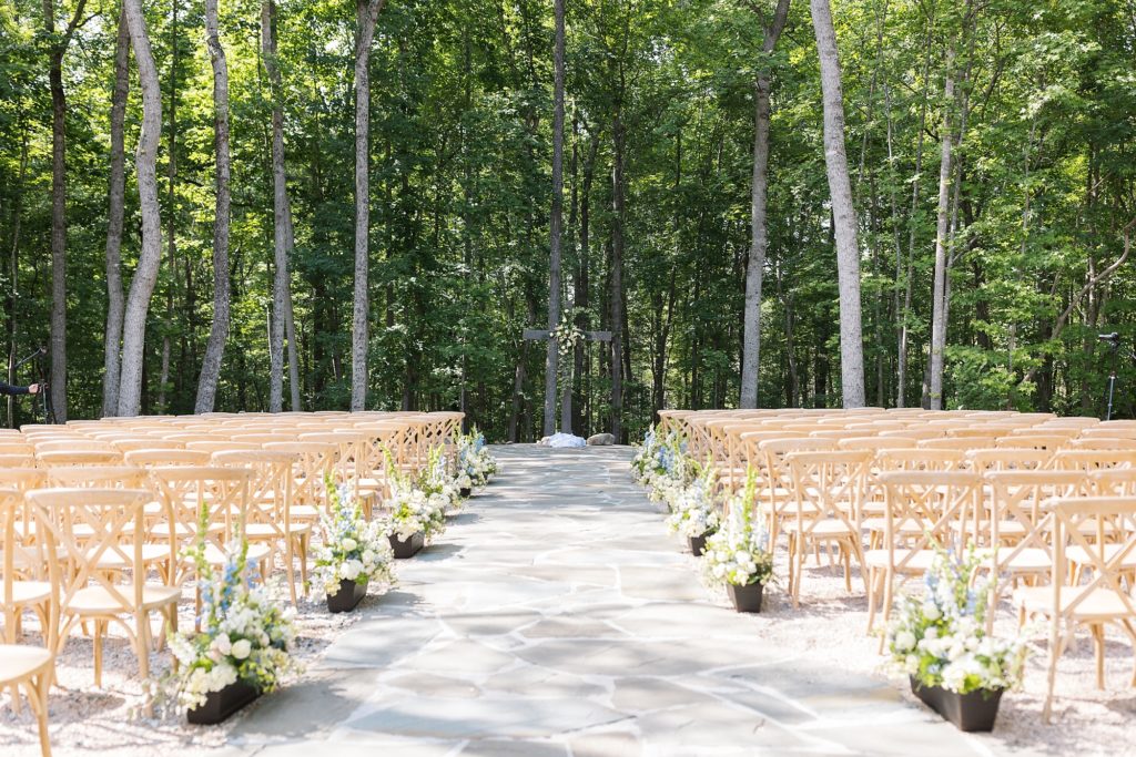 Outdoor ceremony with a wooden cross and flowers on the aisle | Carolina Grove | Raleigh NC Wedding Photographer | Sarah Hinckley Photography