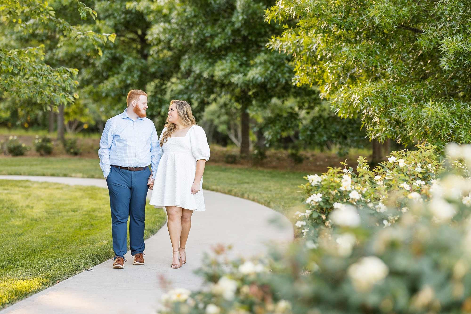 Beautiful spring engagement photo with flowers in a park in Raleigh | Raleigh NC Engagement Photographer