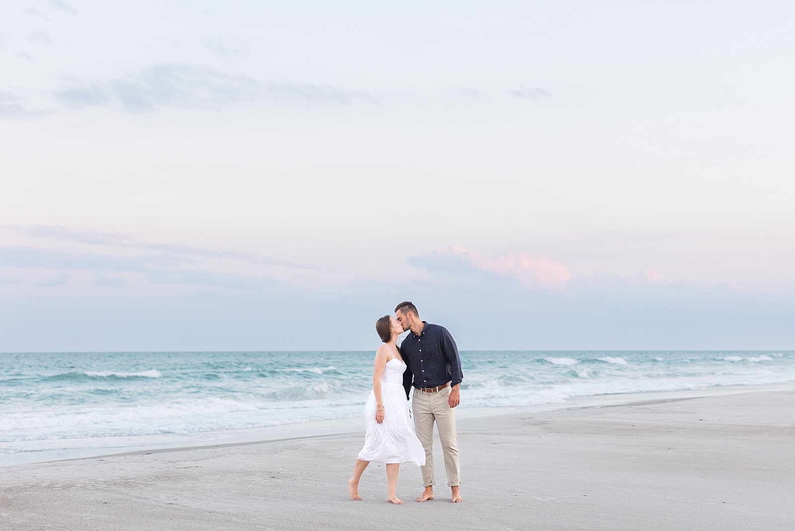 Engagement photos on the beach at Topsail during sunset with pink skies | Raleigh North Carolina Wedding Photographer