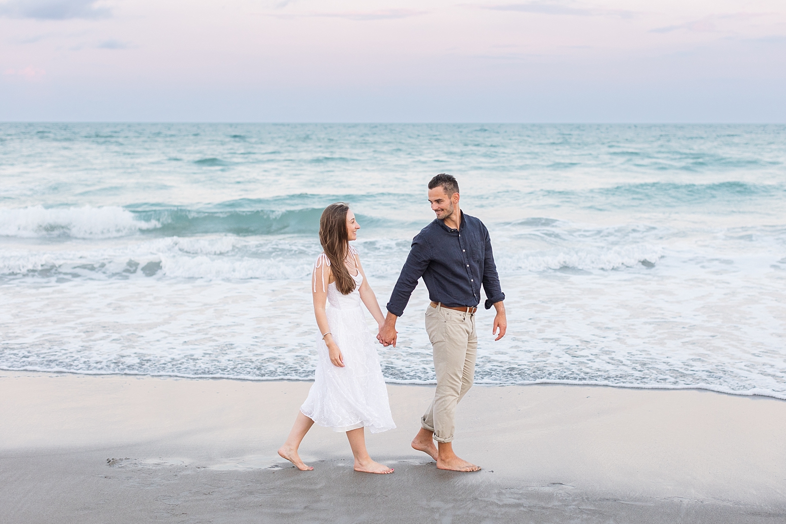 Engagement photos on the beach at Topsail during sunset with pink skies | Raleigh North Carolina Wedding Photographer