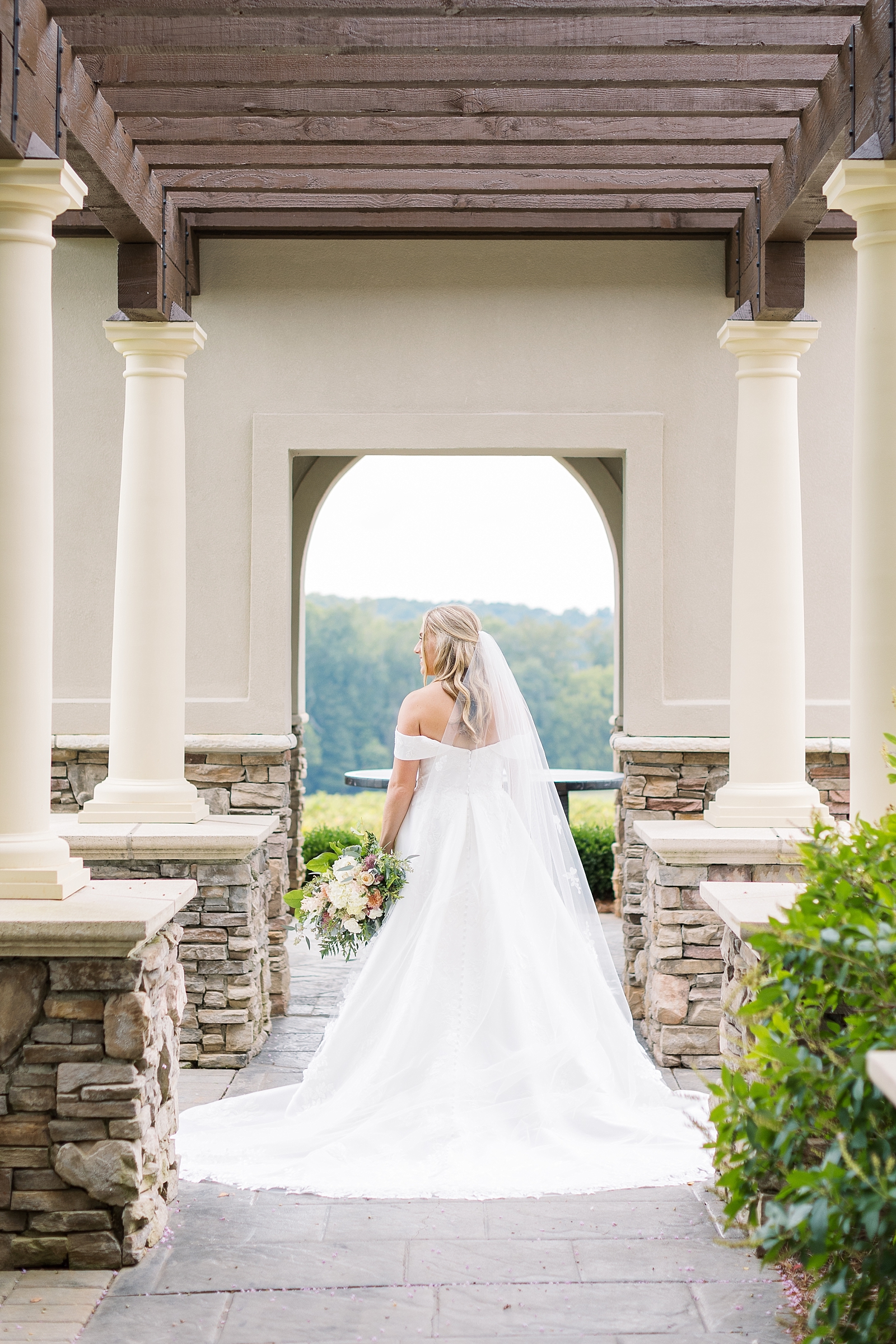bride standing in archway Childress Vineyards   | NC Wedding Photographer | VA wedding photographer | Vineyard Weddings