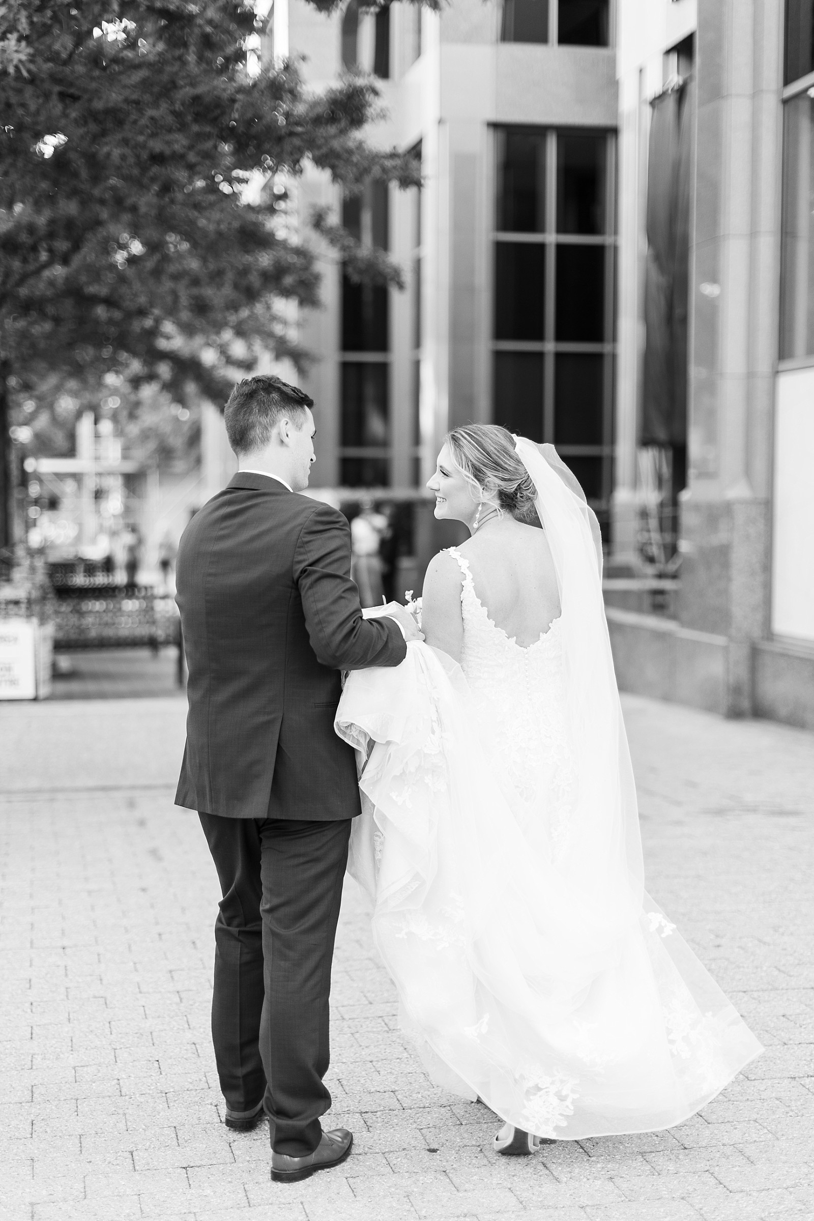 Bride and groom walking in downtown Raleigh | Raleigh Wedding Photographer Sarah Hinckley