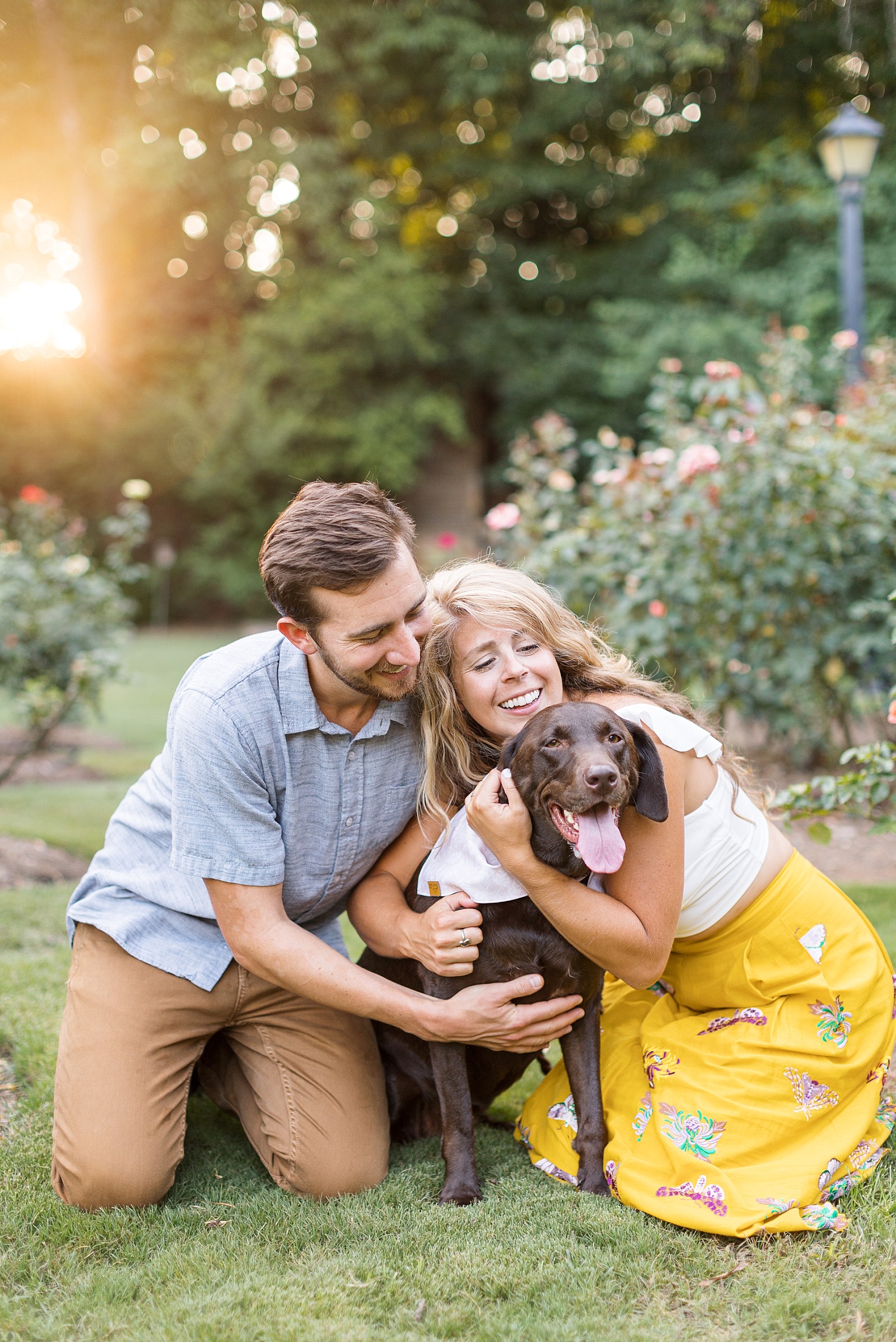 couple hugging their dog during Raleigh Rose Garden Anniversary Photos | Raleigh Portrait Photographer | Raleigh NC Wedding Photographer