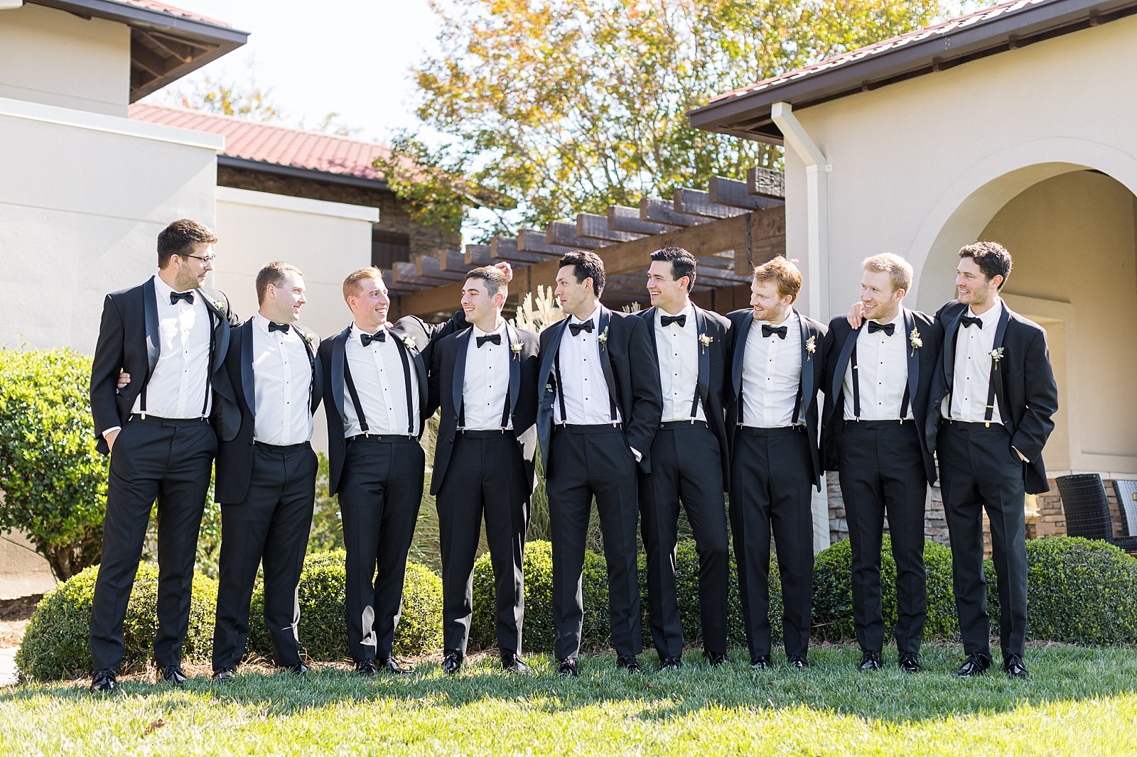 groomsmen wearing black suits with suspenders and bowties | Childress Vineyards Wedding | NC Wedding Photographer 