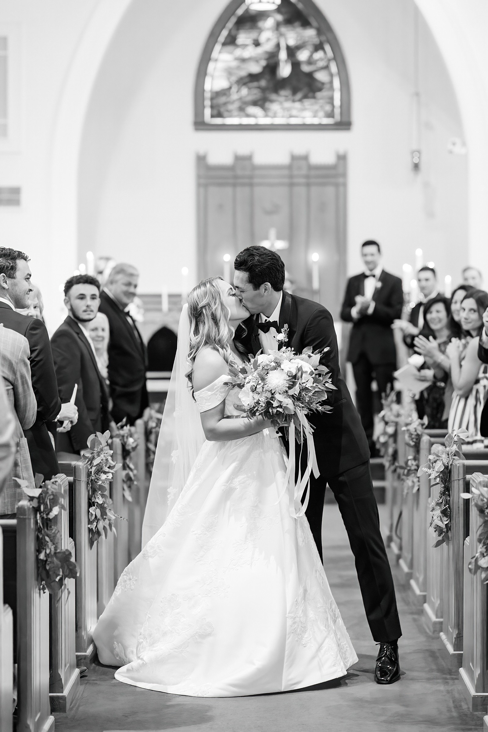 bride and groom kissing down the aisle | NC Wedding Photographer 
