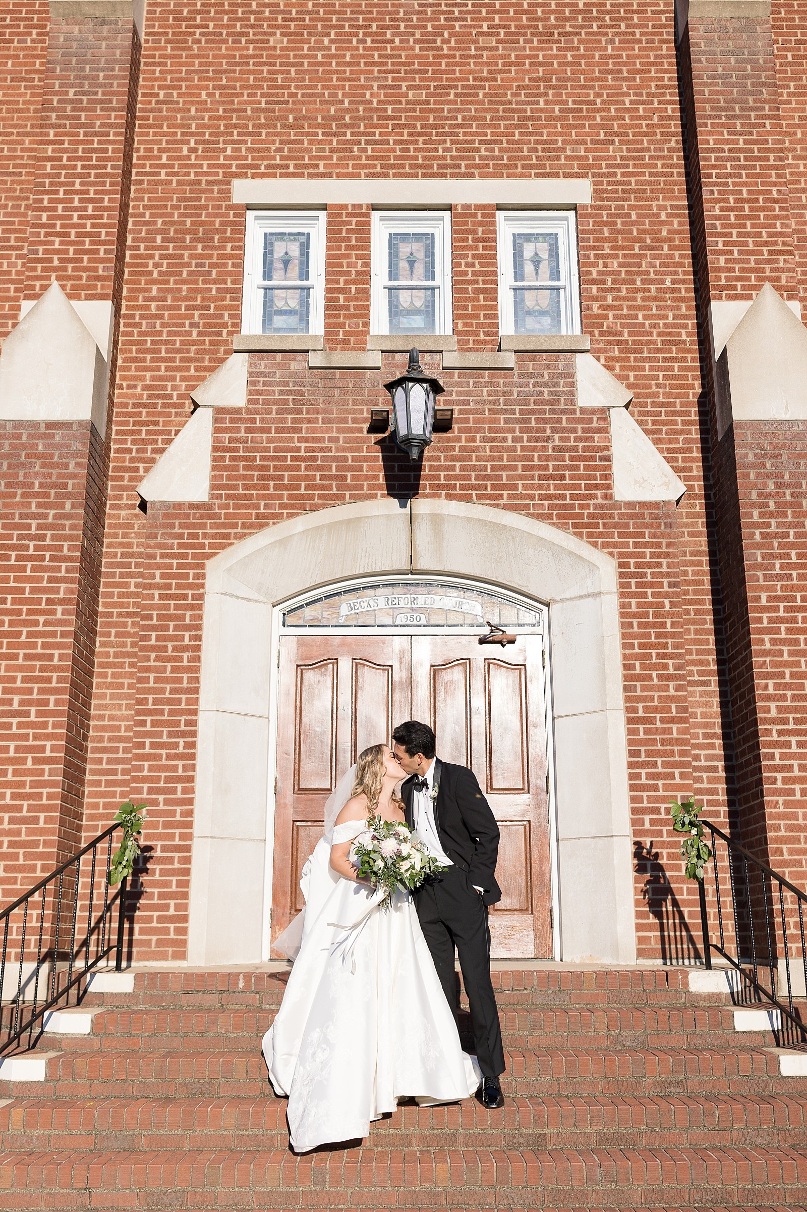 bride and groom kissing in front of chruch  | NC Wedding Photographer 