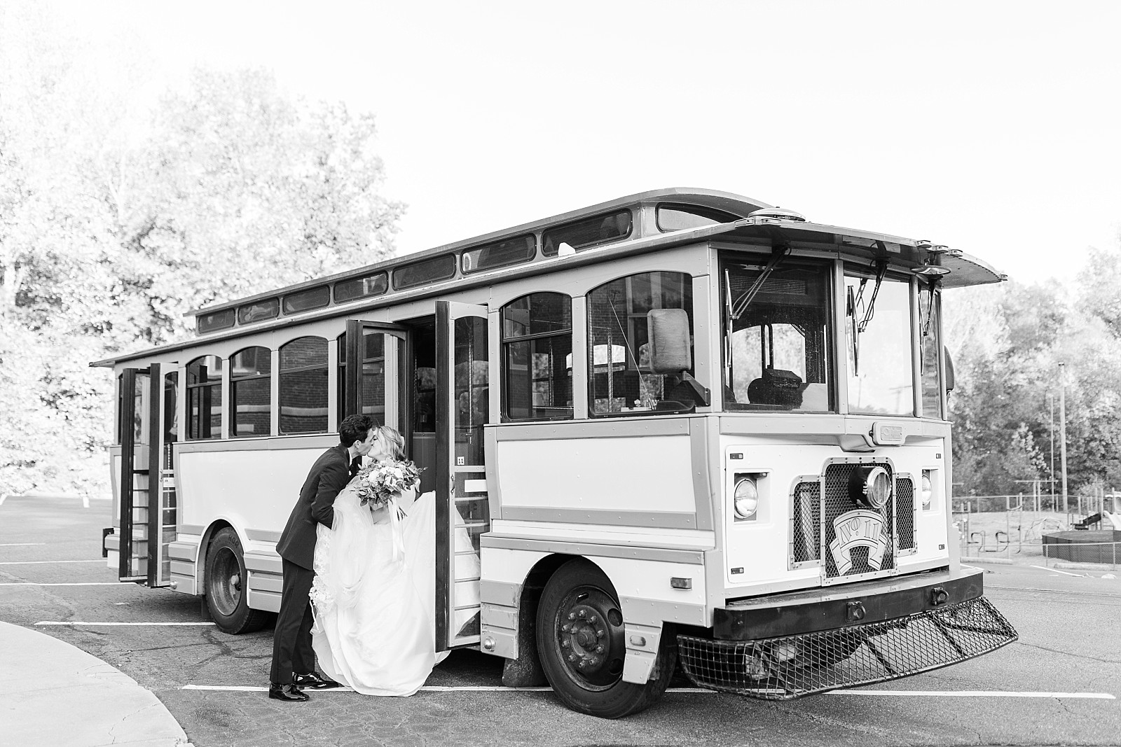 bride and groom kissing in front of trolley | Childress Vineyards Wedding | winery wedding | charlottesville | NC Wedding Photographer 