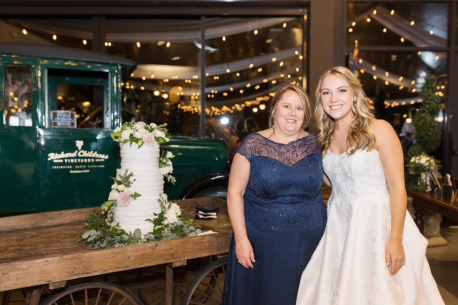 bride with her mom standing in front of the cake she madeh | Childress Vineyards Wedding  | NC Wedding Photographer 