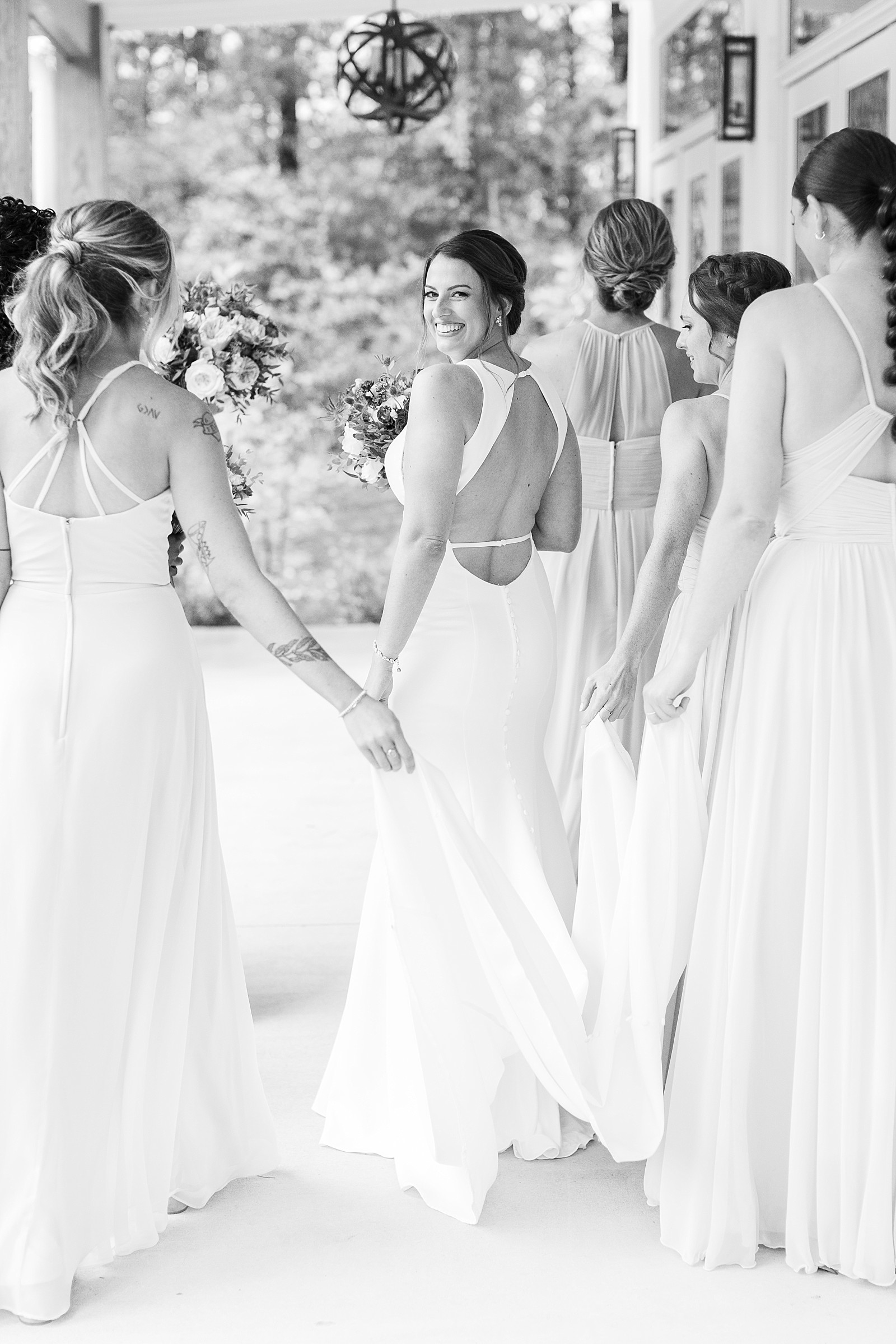 black and white photo of bride with her bridesmaids at The Upchurch in Cary NC | Raleigh NC Wedding Photography