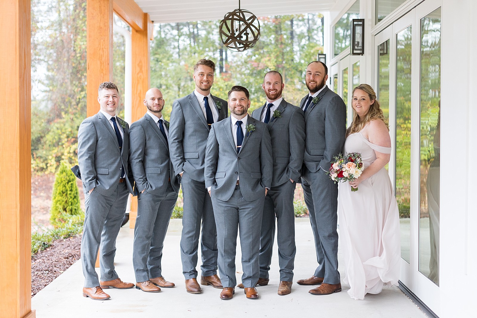 Groomsmen and woman outside The Upchurch in Cary NC | Raleigh NC Wedding Photography