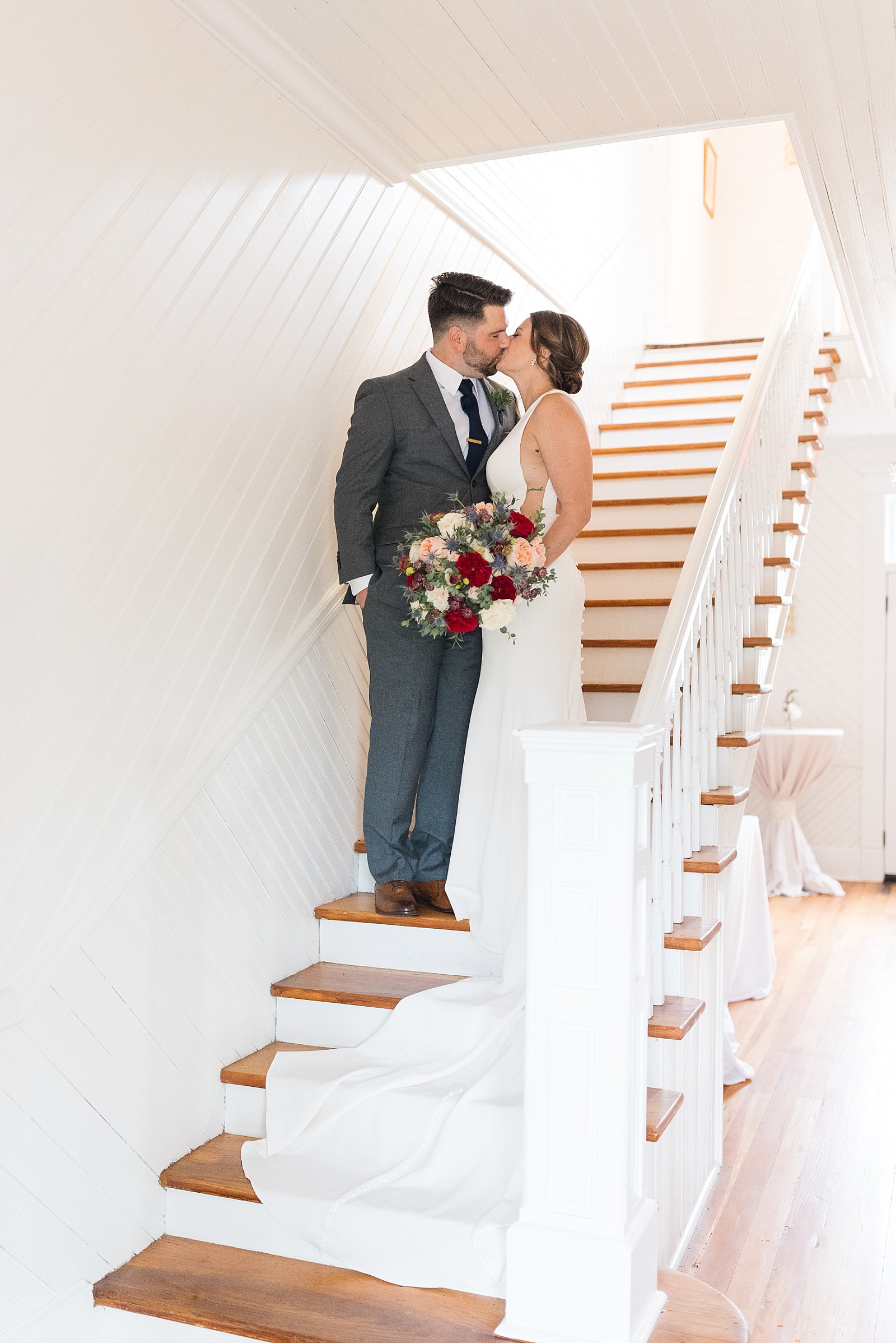 Bride and groom kissing on stairwell at The Upchurch in Cary NC | Raleigh NC Wedding Photography