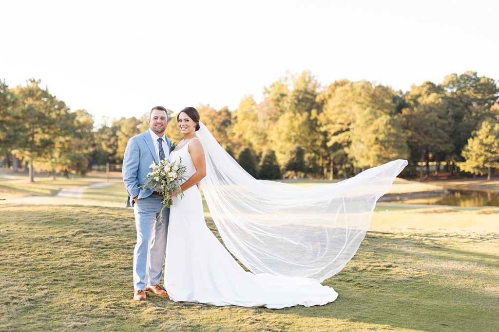 bride and groom with brides veil blowing in the wind | Bentwinds Country Club Wedding | Fall Wedding | North Carolina Wedding | Raleigh NC Wedding Photographer | Sarah Hinckley Photography
