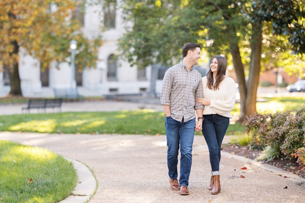 Couple walking in the city park | Downtown Raleigh Engagement Photoshoot | Raleigh NC Wedding & Engagement Photographer | Sarah Hinckley Photography 