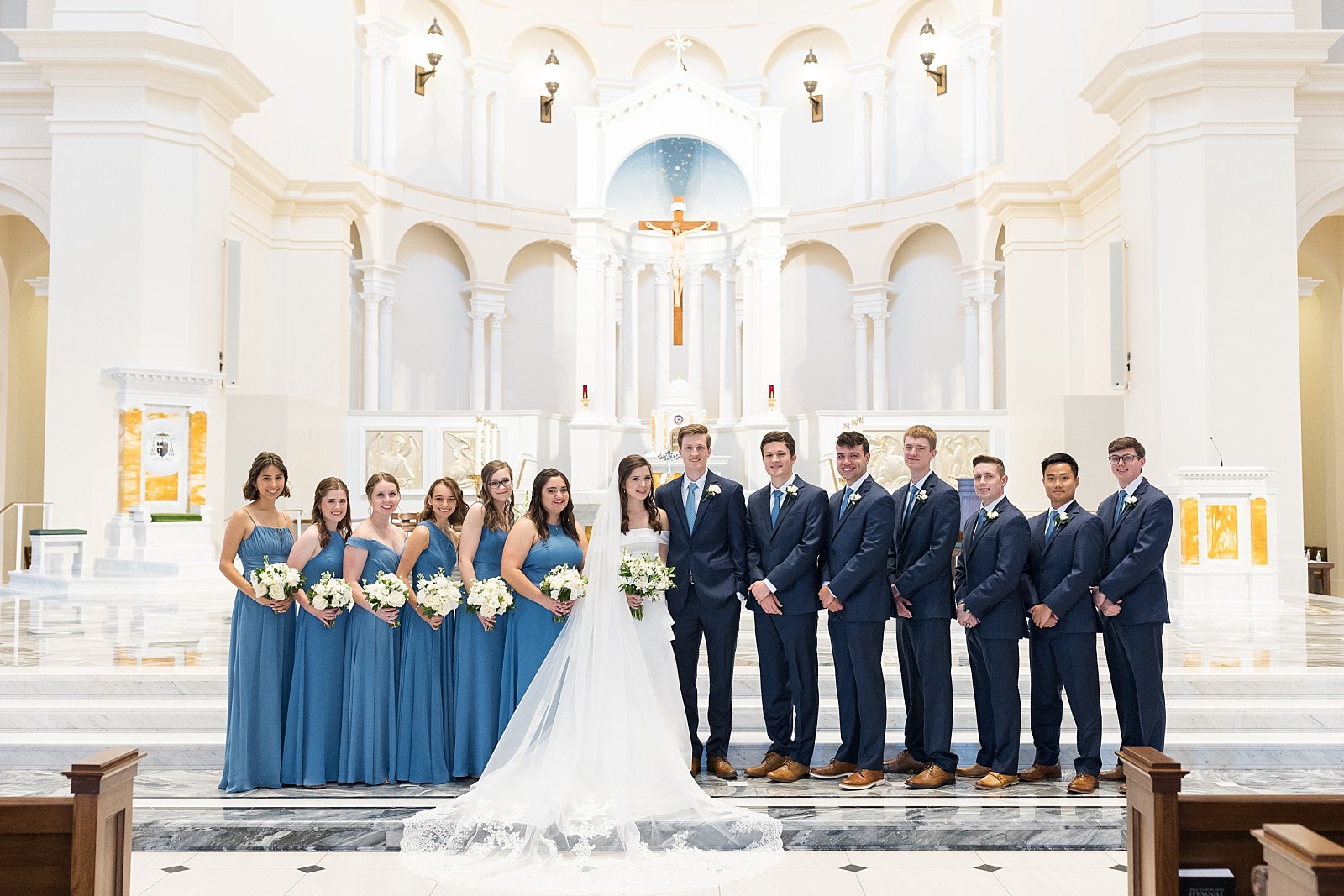 bride and groom with their bridal party at the church