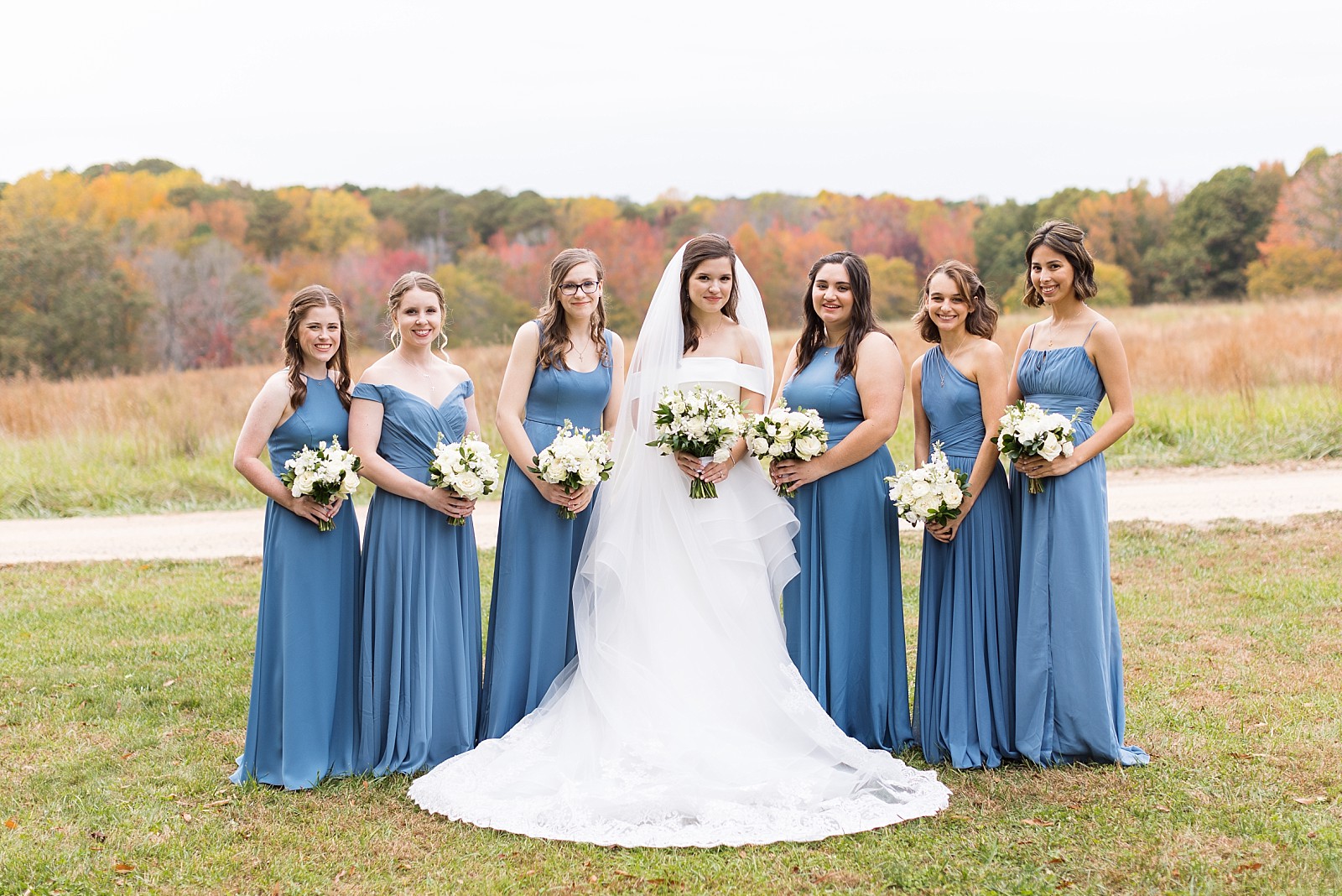 Bride with her bridesmaids wearing blue   | Fall Wedding at The Meadows in Raleigh | Raleigh NC Wedding Photographer