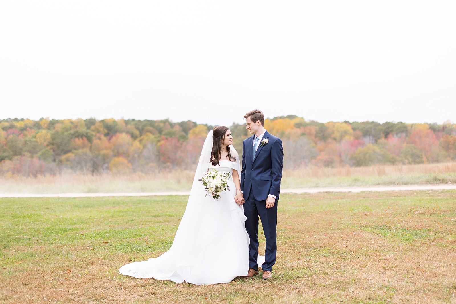 Bride and groom standing in the meadow | Fall Wedding at The Meadows in Raleigh | Raleigh NC Wedding Photographer