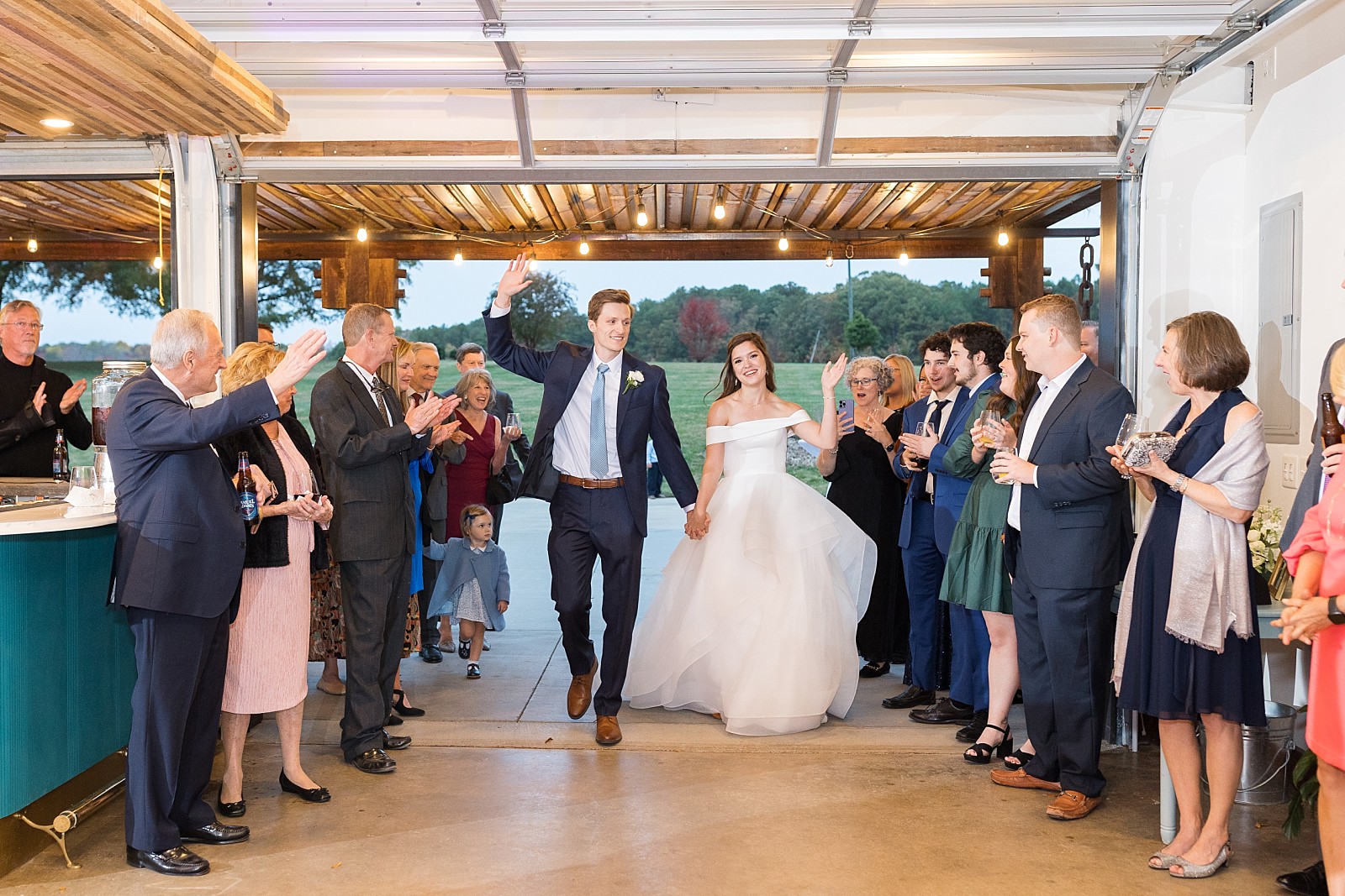 bride and groom entering reception  | The Meadows in Raleigh | Raleigh NC Wedding Photographer