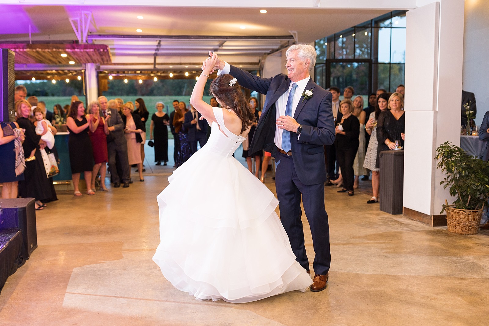 father of the bride twirling his daughter during their dance  | The Meadows in Raleigh | Raleigh NC Wedding Photographer