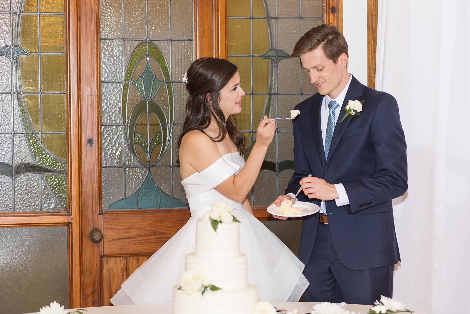 Bride feeding groom cake  | The Meadows in Raleigh | Raleigh NC Wedding Photographer