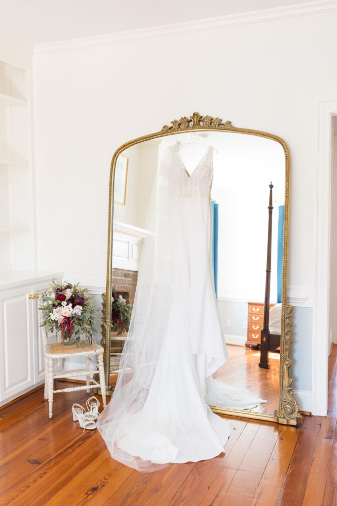 wedding dress hanging on antique gold mirror | Fall wedding at Walnut Hill in Raleigh NC | Raleigh NC wedding photographer 