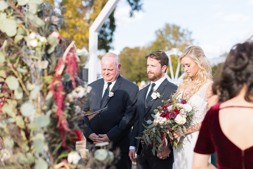 bride with her groom and father at the alter  | Fall wedding at Walnut Hill in Raleigh NC | Raleigh NC wedding photographer 