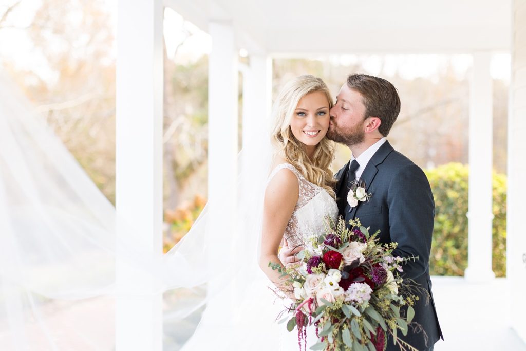 bride and groom with bride's veil blowing in the wind | Fall wedding at Walnut Hill in Raleigh NC | Raleigh NC wedding photographer 
