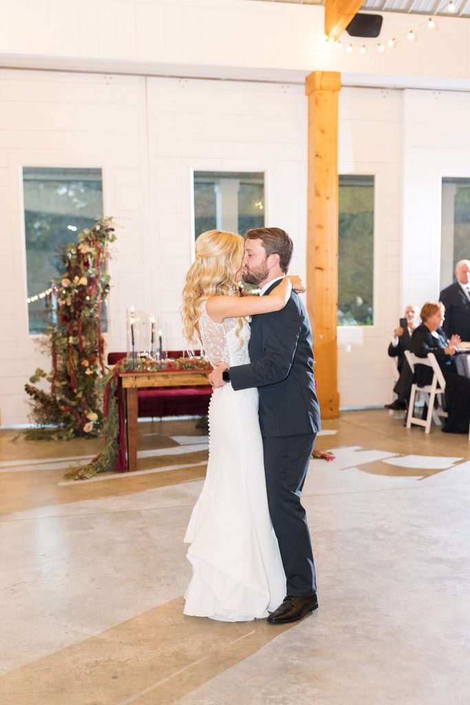 bride and groom sharing a kiss during their first dance | Fall wedding at Walnut Hill in Raleigh NC | Raleigh NC wedding photographer 