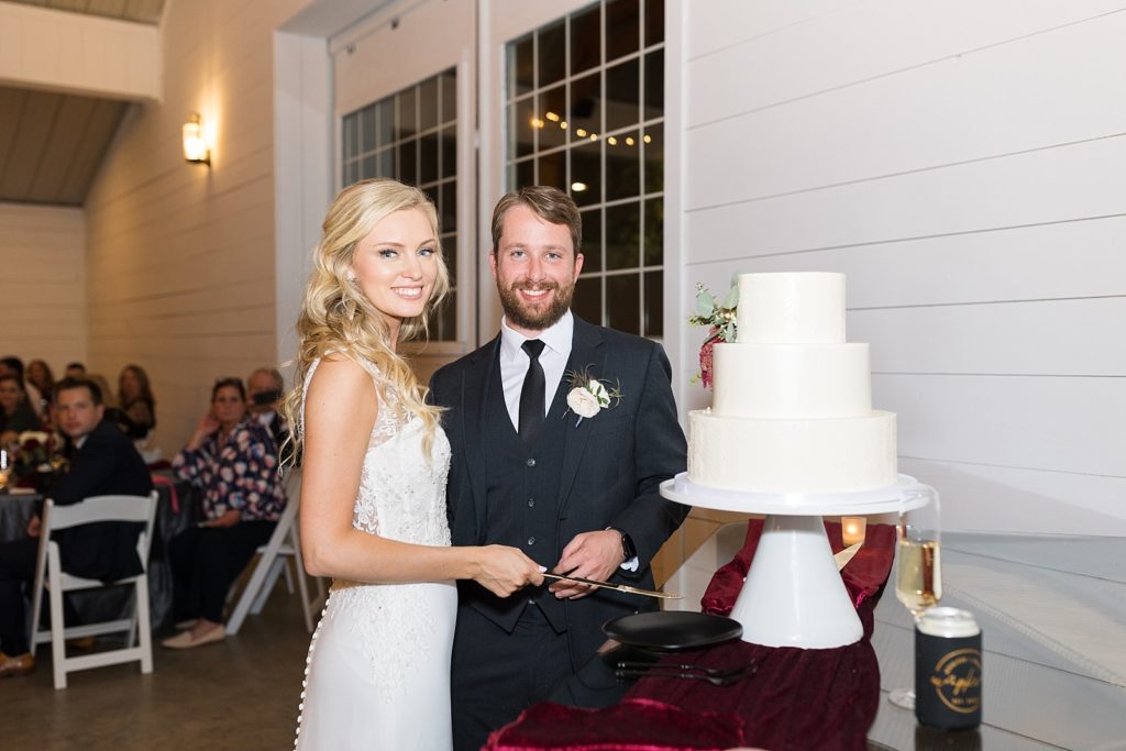 bride and groom cutting their cake | Fall wedding at Walnut Hill in Raleigh NC | Raleigh NC wedding photographer 