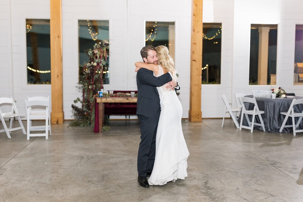 bride and groom sharing a private last dance guests dancing | Fall wedding at Walnut Hill in Raleigh NC | Raleigh NC wedding photographer 