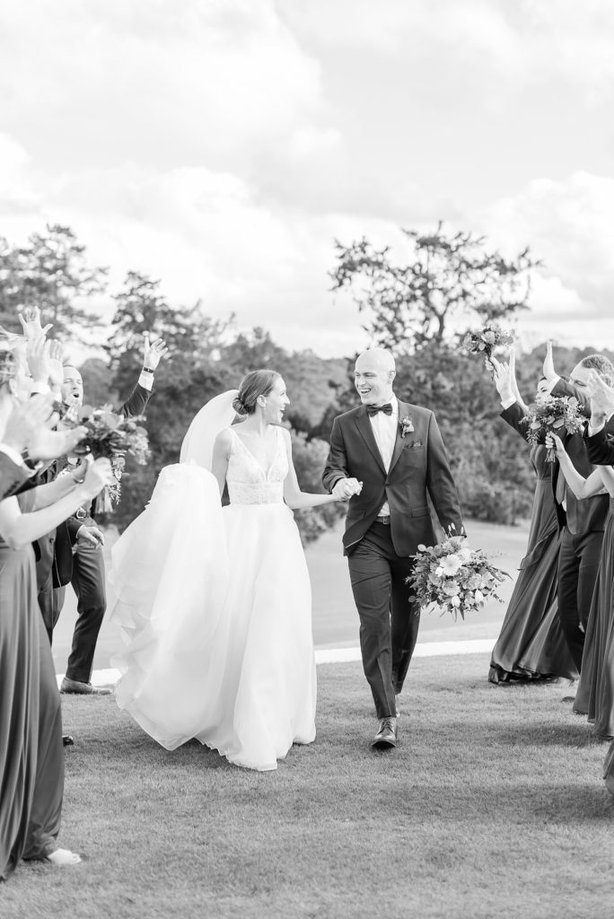 black and white photo of bride and groom walking | Fall wedding at Hope Valley Country Club | Durham Wedding | Raleigh NC wedding photographer 