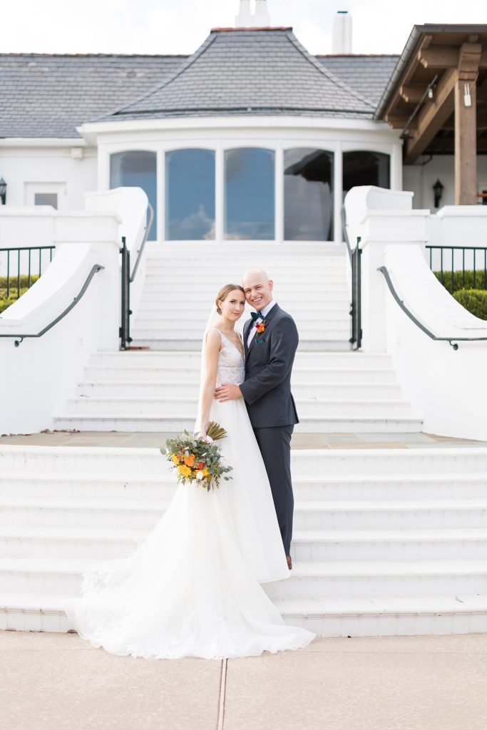 Bride and groom in front of venue stairs | Fall wedding at Hope Valley Country Club | Durham Wedding | Raleigh NC wedding photographer 